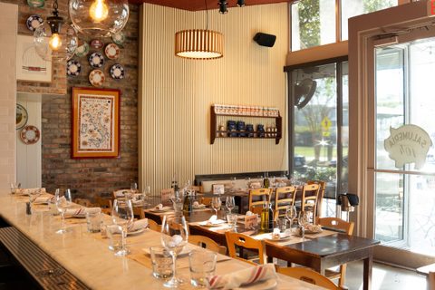 Tables set for a private event at Salumeria 104 Midtown