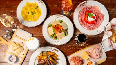 Antipasti spread on a marble table at Salumeria 104 Midtown