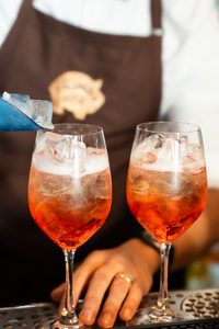 Aperol Spritz cocktail with orange wheel at Salumeria 104 happy hour