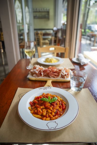 Hand-rolled pasta plated tableside at Salumeria 104 Midtown