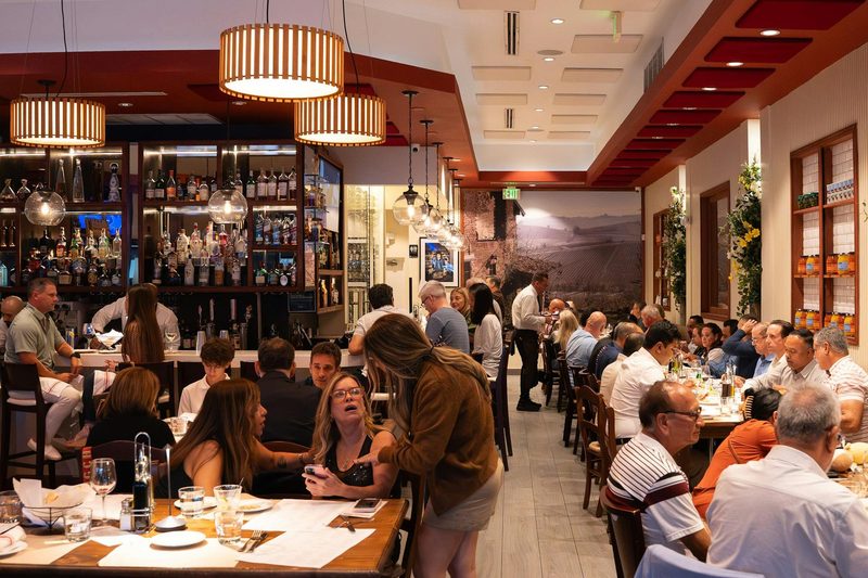 A full dining room during an event at Salumeria 104 Weston